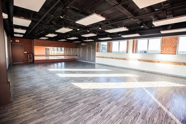 Our practice room is a spacious 1200 SF area with tons of natural light and beautiful original exposed brick.