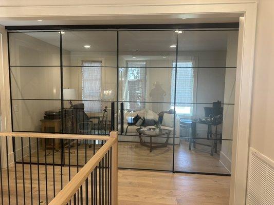 This is a sliding glass partition that creates a home office area.