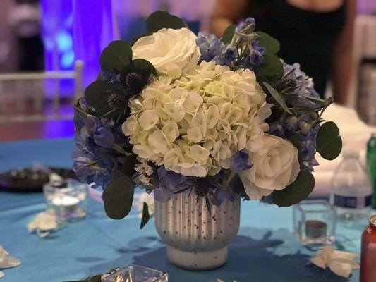 Table centerpiece , fresh flowers in silver vase.