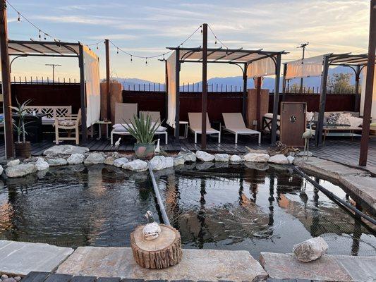 Koi pond and shaded lounge areas.