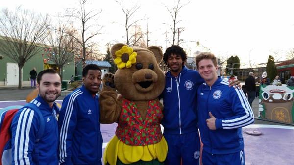 Mum Bear, the Camden Children's Garden Mascot visits with the 76ers Basketball Team