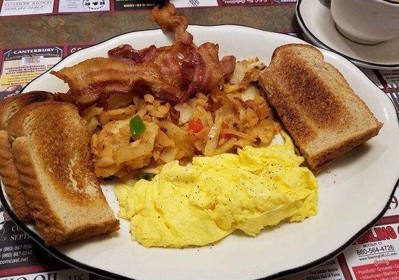 2 scrambled eggs, home fries with onions, bacon an wheat toast. Coffee.