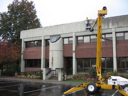 Older Stucco building cleaning using eco safe detergents. But unfortunately this customer waited too long where the mold attack the stucco.