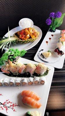 Front: Spicy yellowtail roll, crunchy shrimp roll, and salmon nigiri Right: Rainbow roll  Back left: pineapple chicken