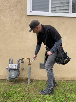 Using a leak detector at the gas meter to identify a small leak you cannot smell.