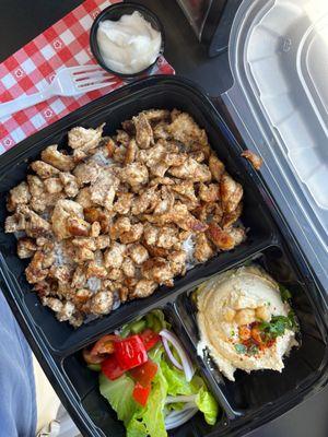 Chicken kebob rice plate with hummus, salad and pita bread