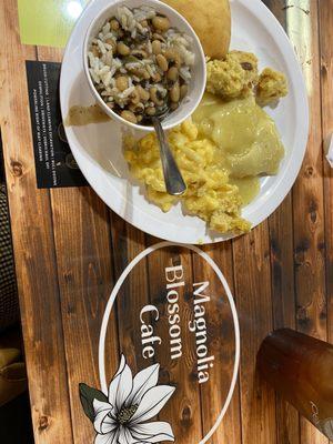 Homemade black eye peas and rice, chicken and dumplings , dressing and a roll