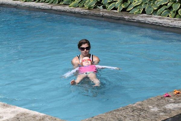 AquaMobile instructor teaching her student how to do the back float.