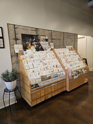 A display of greeting cards at the entrance of Bread Craft for sale.