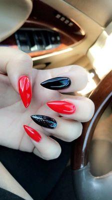 Black and red stiletto shape usually a lot of places don't shape them correctly but at Lucky nails they did a great job