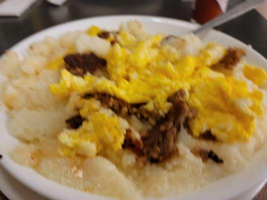 Sausage, scrambled eggs, cheese, and grits.