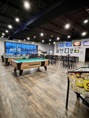 Dining area with pool tables and pinball machines