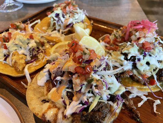 A variety of tacos (Fried Fish Taco, Fried Shrimp Taco, Surf & Turf Taco, and Carne Asada Taco)