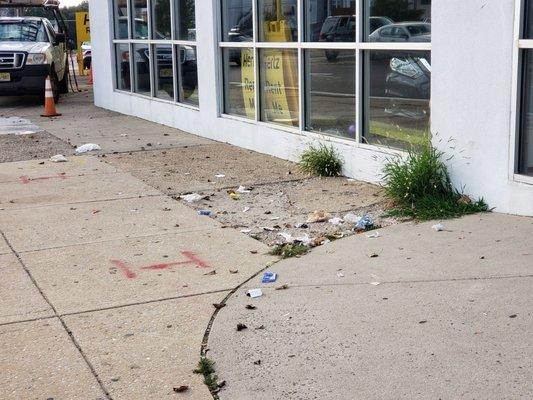 Trash all over the sidewalk.