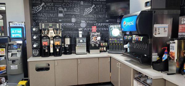 Efficient beverage bar area ATM right by the truck or entrance door coffee cappuccino fountain drinks