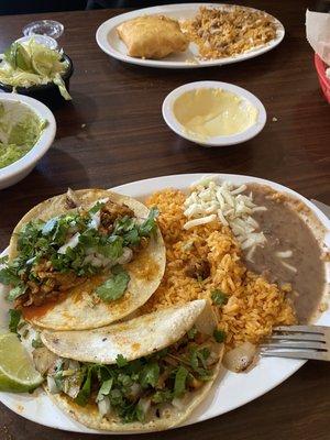 What's left of Al pastor tacos and chicken chimichanga, cheese dip, guacamole