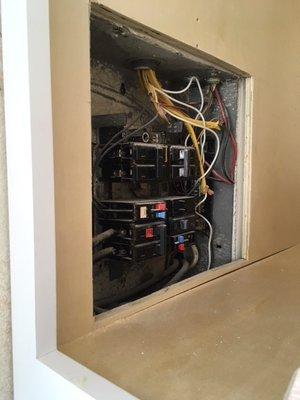 Electric panel in a cupboard. Not code or safe. Just cut a hole in my brand new pantry - that's cool.