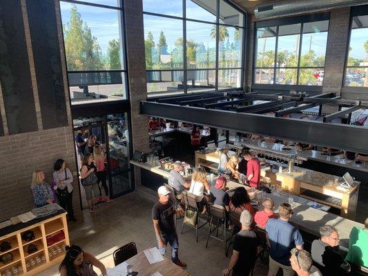 Looking down from loft area to the indoor/outdoor wrap around bar and host stand.