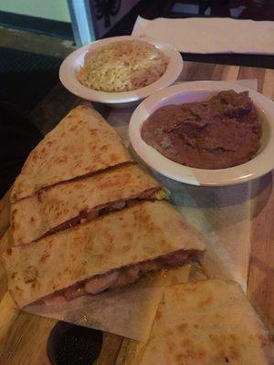 Chicken Quesadilla with refried beans and rice.