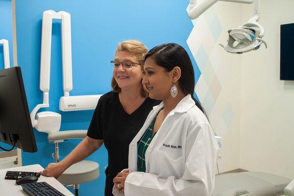 Freehold Township dentist Dr. Prachi Shah planning cosmetic dentistry procedure with dental assistant Helene at Premier Arts Dental