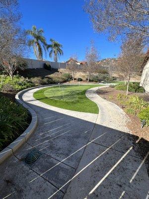 New concrete, drains, artificial grass and putting green!