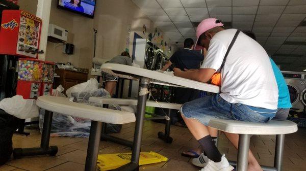 One of two tables to sit at while you wait. Other benches & folding tables, but nothing to wait at.