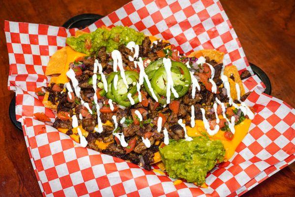 The best nachos you can find topped with your choice of meat