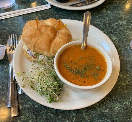 #6 chicken salad sandwich on croissant roll with tomato basil soup.