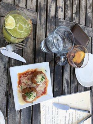 Arancini and cocktails at happy hour