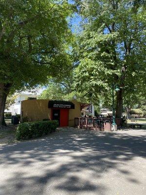 Outside nestled within a beautiful canopy of trees