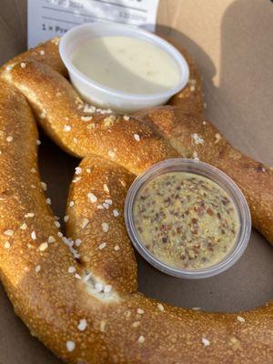 Pretzel with cheese sauce and mustard