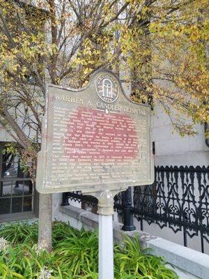 Historical marker next to building by the parking area.