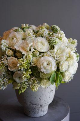 "Elegy in Ivory" a floral arrangement with white spray roses and white ranunculus in a pavé style