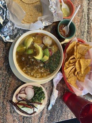 Carne en su jugo with garnishes and corn tortilla