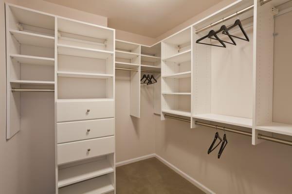 Ample closet space with adjustable shelving and custom storage