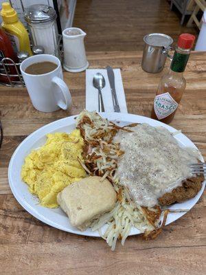 Chicken fried steak and gravy with scrambled eggs, biscuits and gravy.