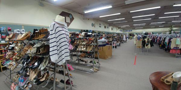 Looking down the aisle of shoe racks.