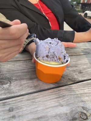 Scoop of pistachio (bottom) and Cookie Monster ice cream (top)