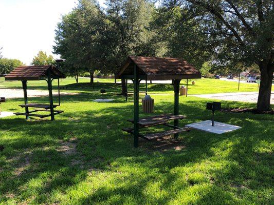 Three covered picnic tables with grills