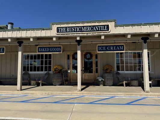 Exterior of The Rustic Mercantile with cozy porch seating.