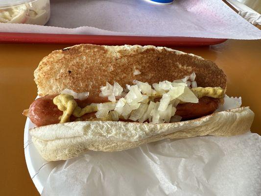 Hummel natural casing hot dog with onions and spicy brown mustard.