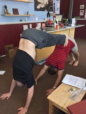 Partner Yoga play in our Lobby. Double Downward Dog!
 Ryan and Mike. Ryan teaches Sundays 11:30 and Yin Yoga as well