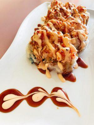 Baked lobster roll 
 Inside: crab, avocado 
 Outside: (baked) lobster mix, eel sauce, and spicy mayo