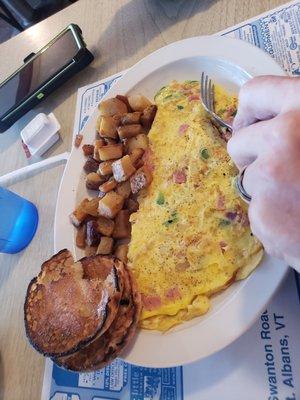 Western omlete with home fries and English muffin.