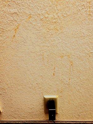 Orange stain splattered on wall