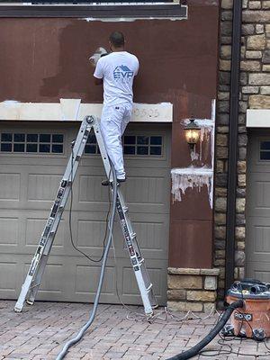 Exterior building stucco repair and repaint