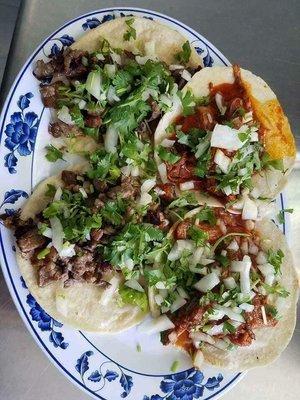 Asada tacos and birria tacos with onions and cilantro. Our tortillas are hand made!