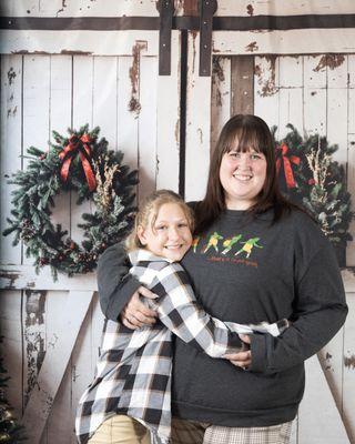 Christmas white shabby barn door background with mom and daughter