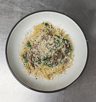 House-made spaghetti with cremini mushrooms, spinach, garlic, shallots, and shaved parmesan in a mushroom cream sauce.