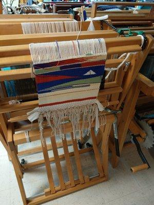 Close up of the folded Looms with projects going on them.